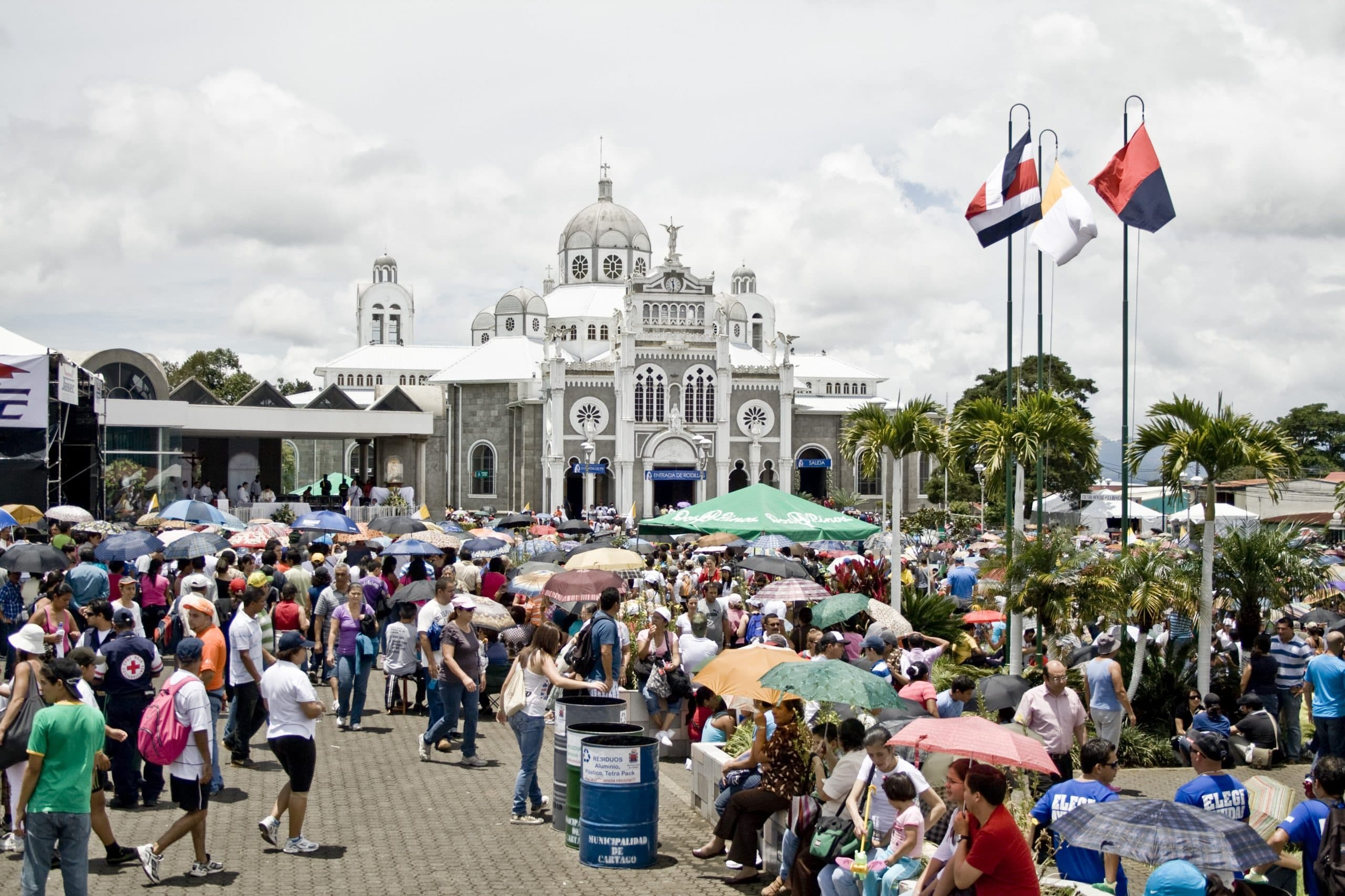 Multitud de romeros con sombrillas llegando a la Basílica de los Ángeles en Cartago